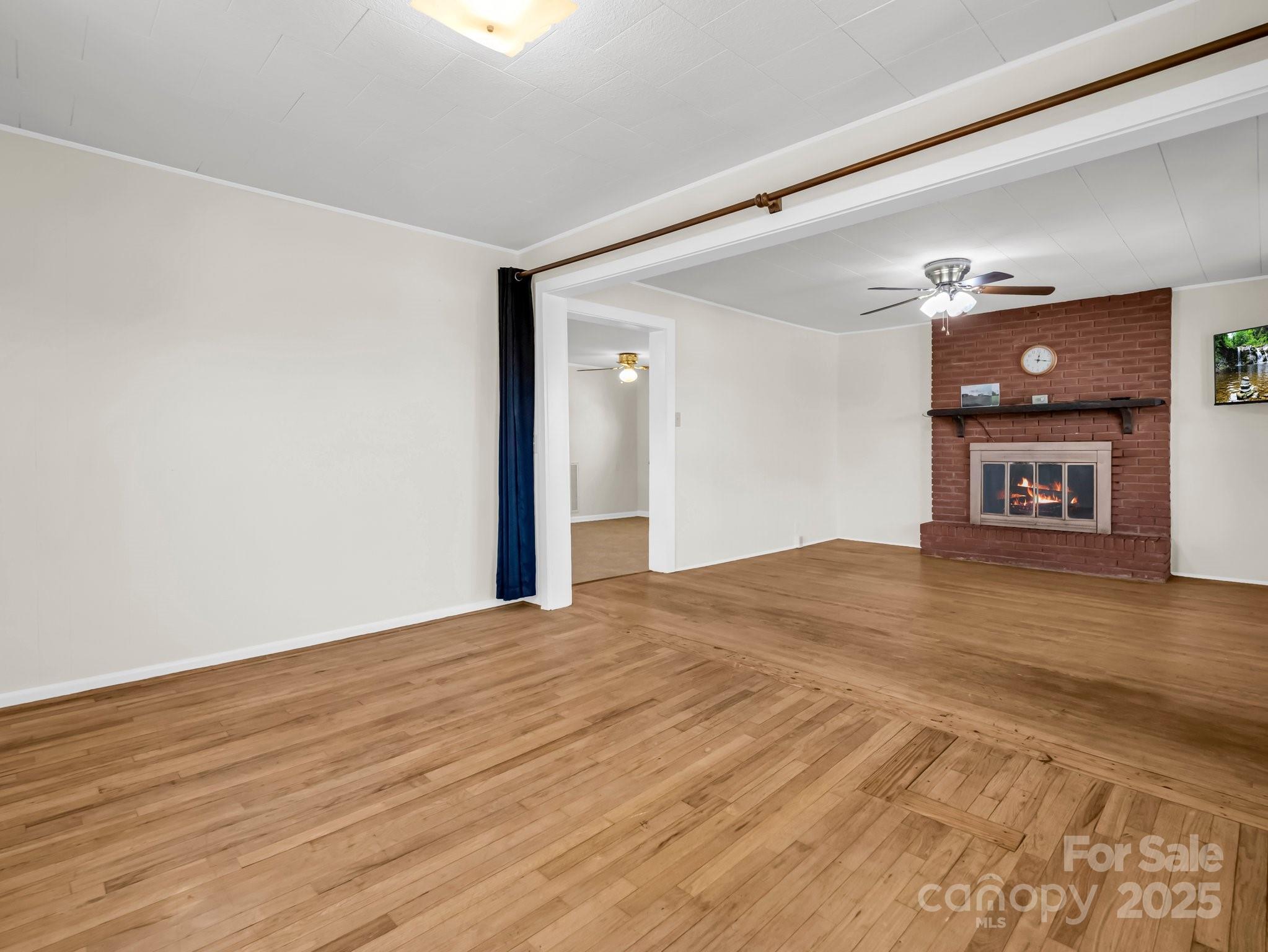 34 Manus Chapel Road Mill Spring, NC 28756 - Photo 14 of 42 a view of empty room with wooden floor