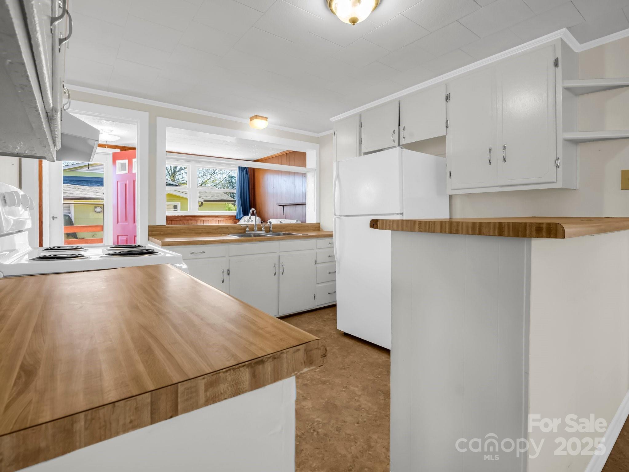 34 Manus Chapel Road Mill Spring, NC 28756 - Photo 17 of 42 a kitchen with stainless steel appliances a sink stove and cabinets