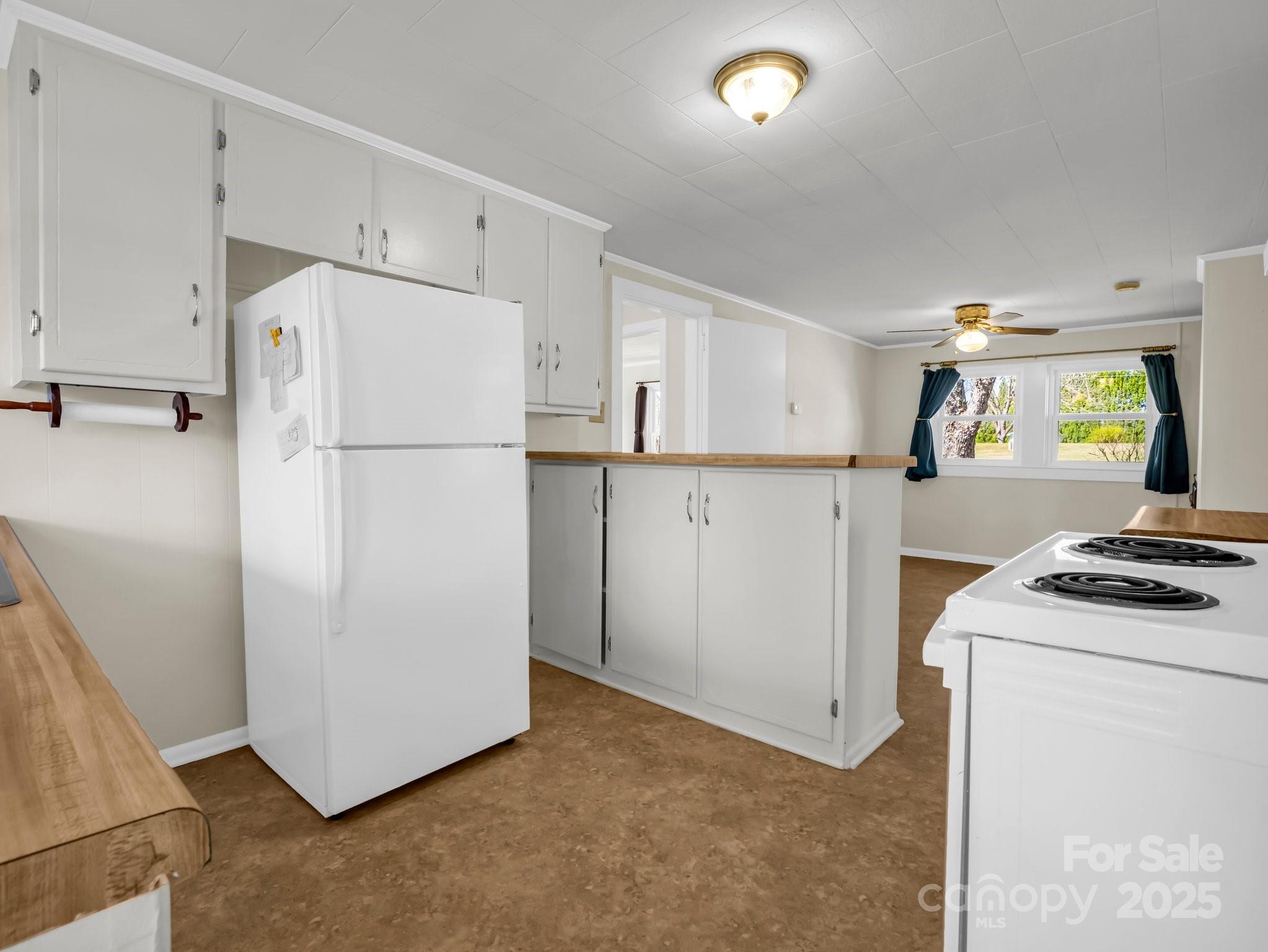 34 Manus Chapel Road Mill Spring, NC 28756 - Photo 18 of 42 a white refrigerator freezer and a stove sitting inside of a kitchen