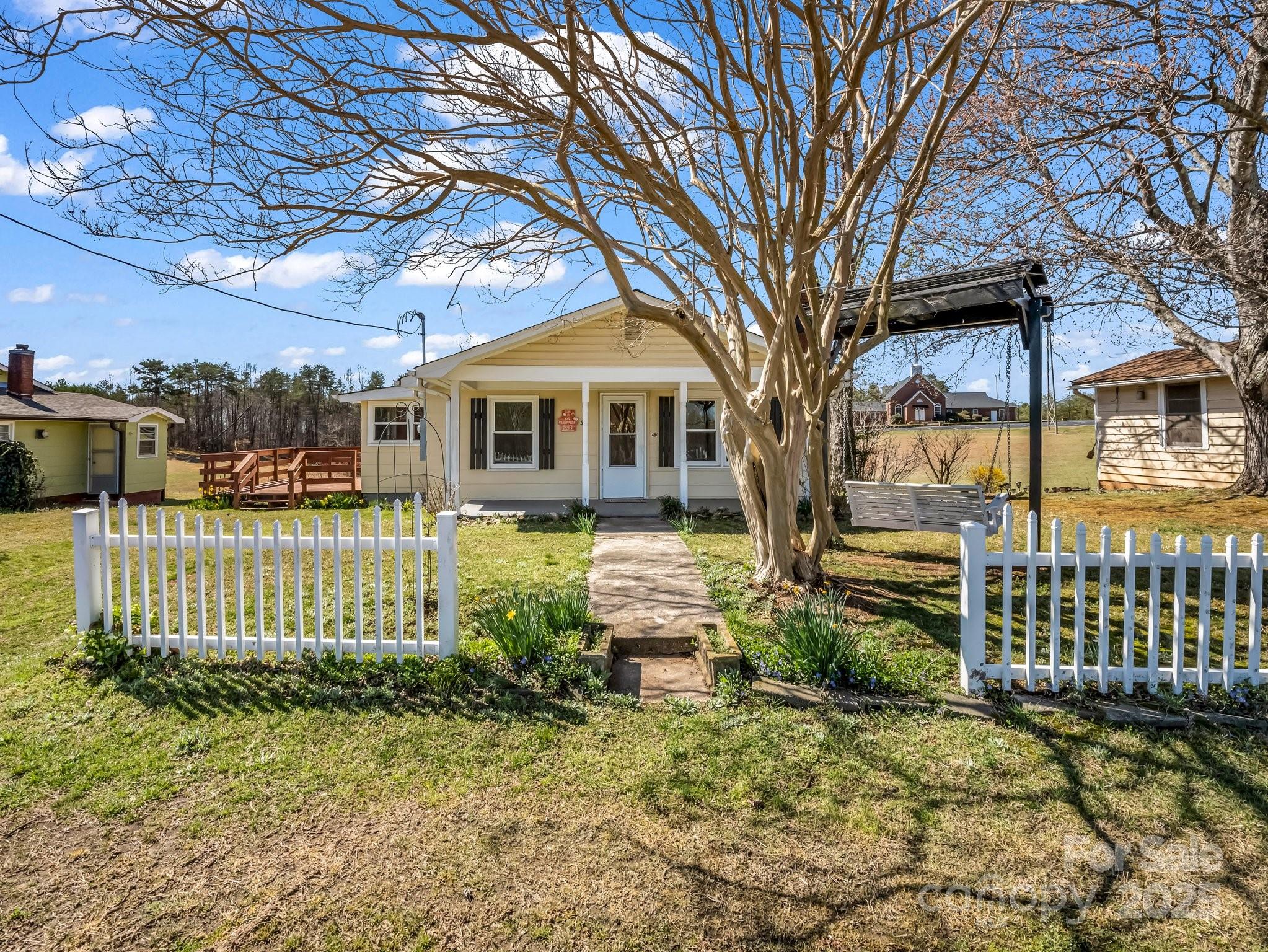 34 Manus Chapel Road Mill Spring, NC 28756 - Photo 2 of 42 a front view of a house with a garden