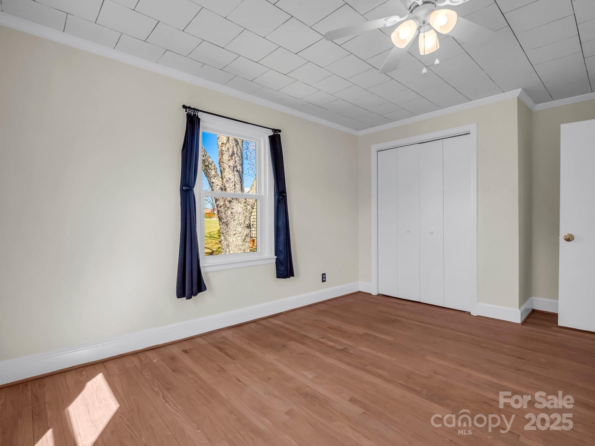 34 Manus Chapel Road Mill Spring, NC 28756 - Photo 25 of 42 a view of an empty room with window and wooden floor