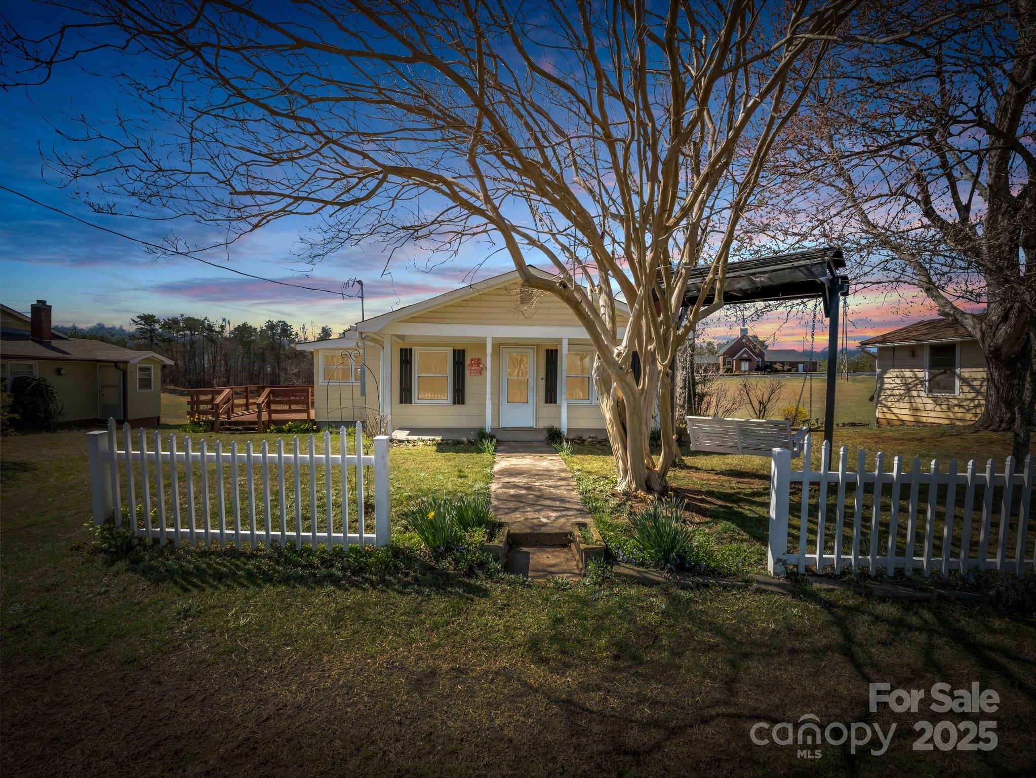 34 Manus Chapel Road Mill Spring, NC 28756 - Photo 35 of 42 a front view of a house with a garden
