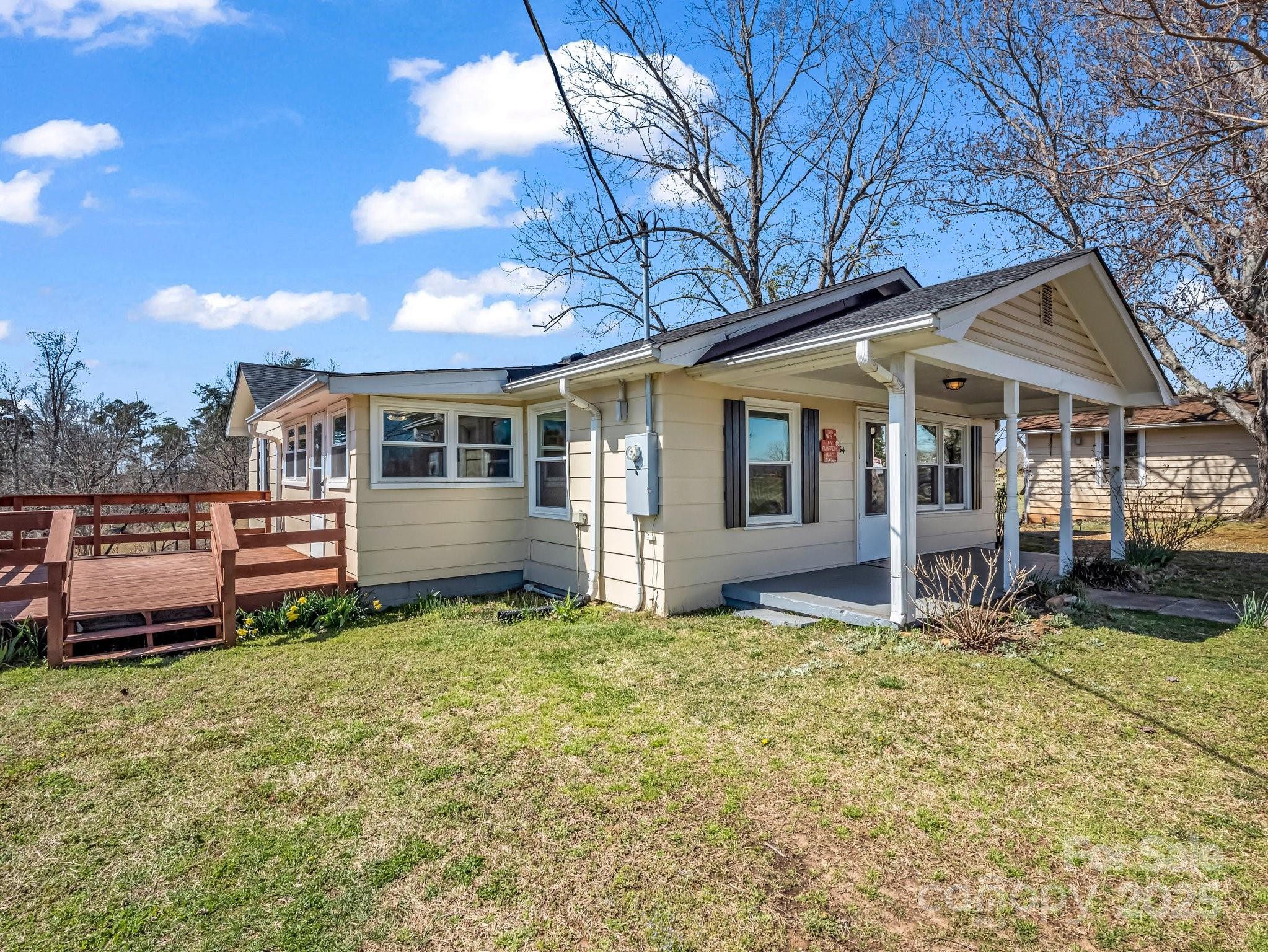 34 Manus Chapel Road Mill Spring, NC 28756 - Photo 4 of 42 a view of a house with a yard and wooden fence