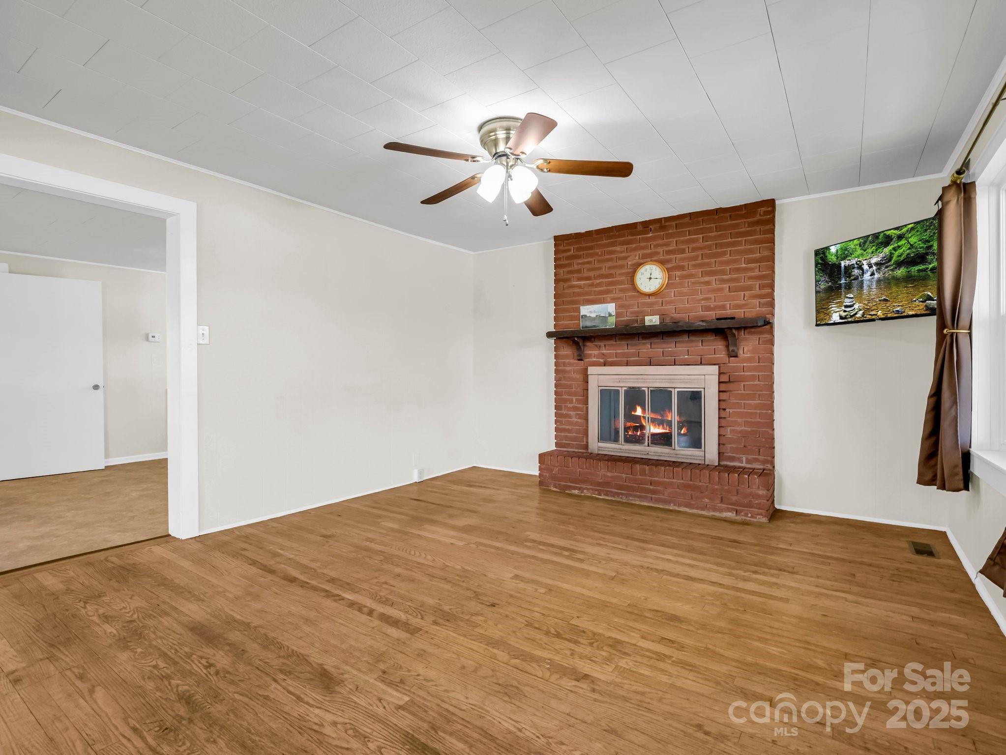 34 Manus Chapel Road Mill Spring, NC 28756 - Photo 10 of 42 a view of empty room with wooden floor