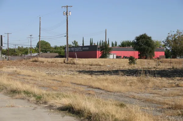 a view of a dirt road and a building