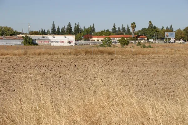 a view of a town with houses on the roadside