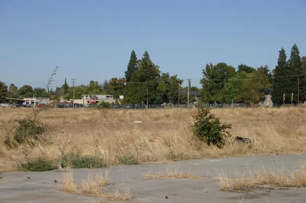 a front view of a house with a yard and lake view