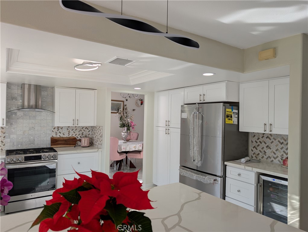 10452 Circulo De Juarez Fountain Valley, CA 92708 - Photo 11 of 34 a kitchen with stainless steel appliances a refrigerator sink and stove