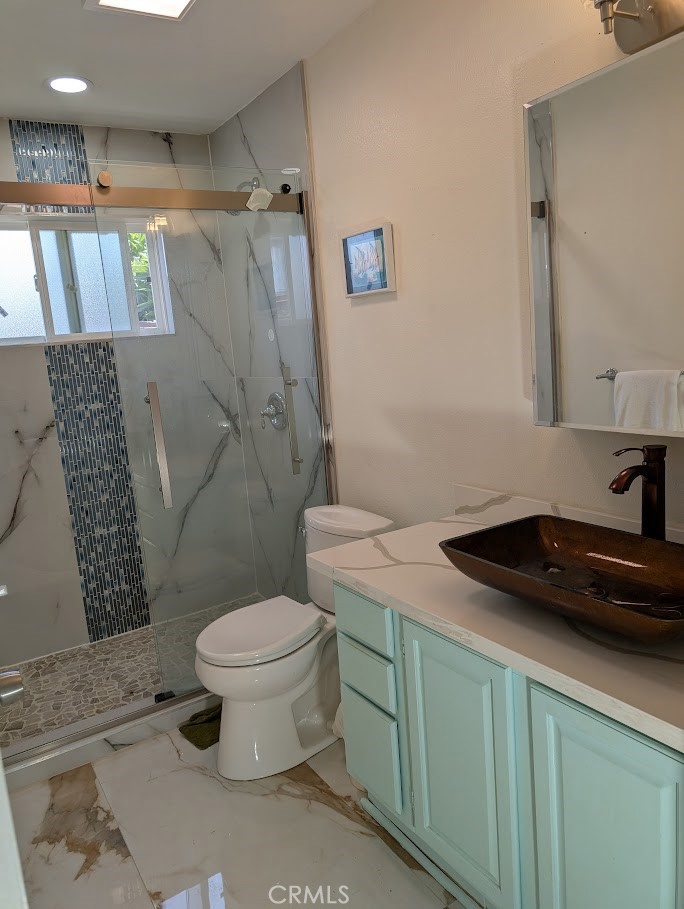 10452 Circulo De Juarez Fountain Valley, CA 92708 - Photo 19 of 34 a bathroom with a granite countertop sink a toilet and a mirror