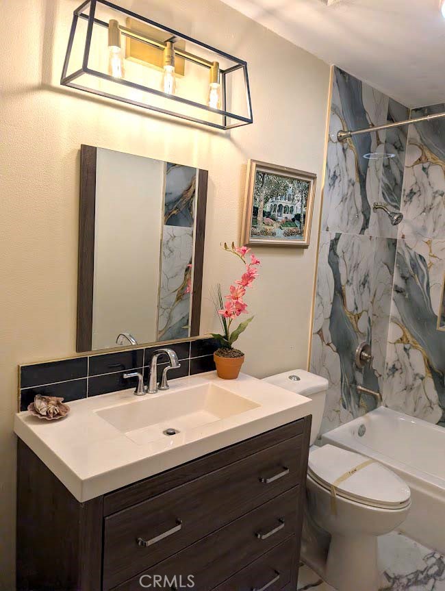 10452 Circulo De Juarez Fountain Valley, CA 92708 - Photo 27 of 34 a bathroom with a sink vanity mirror and toilet