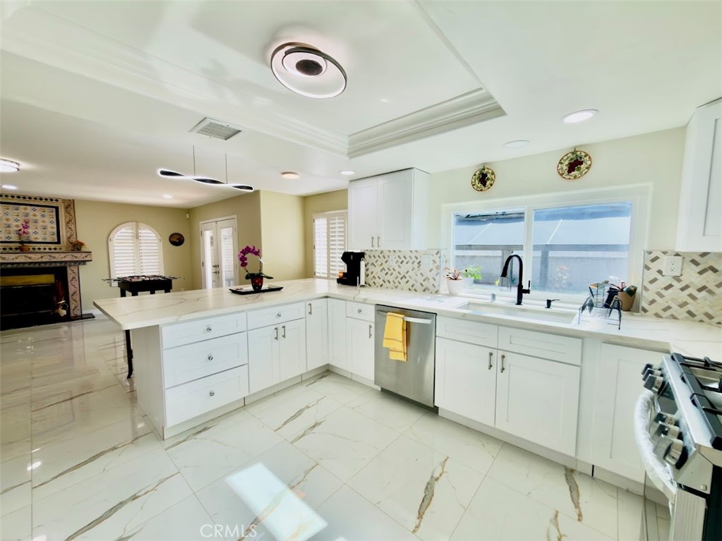 10452 Circulo De Juarez Fountain Valley, CA 92708 - Photo 8 of 34 a large white kitchen with cabinets