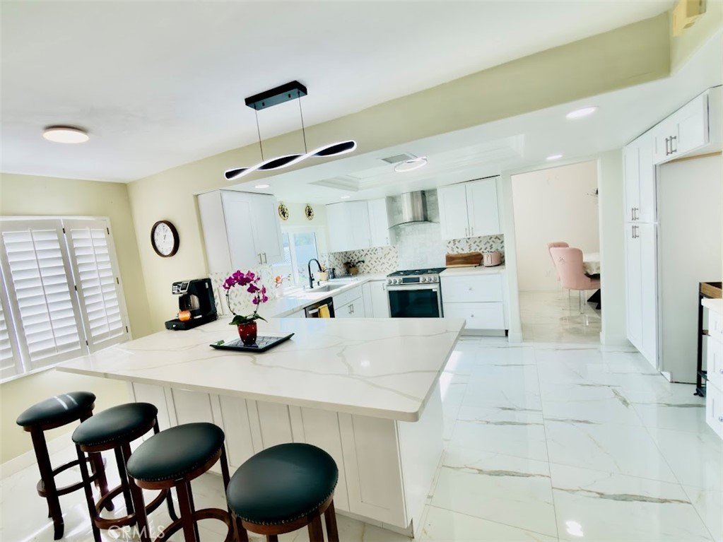 10452 Circulo De Juarez Fountain Valley, CA 92708 - Photo 9 of 34 a kitchen with a table chairs and a dining table
