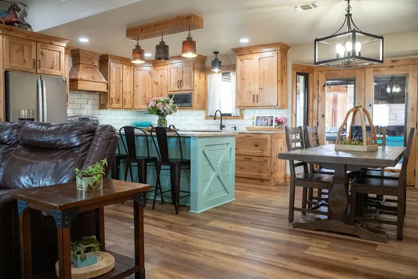 a kitchen with wooden floor and a fireplace