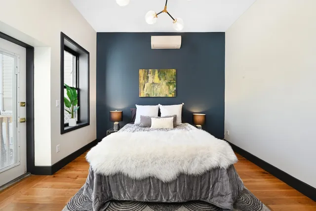 a bedroom with a bed and window