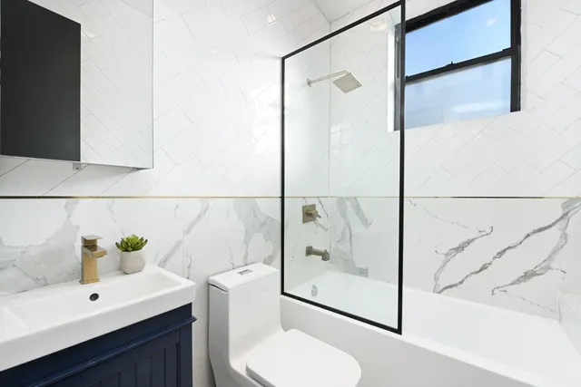 a bathroom with a shower and a sink