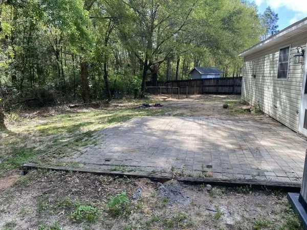 a view of a backyard with large trees