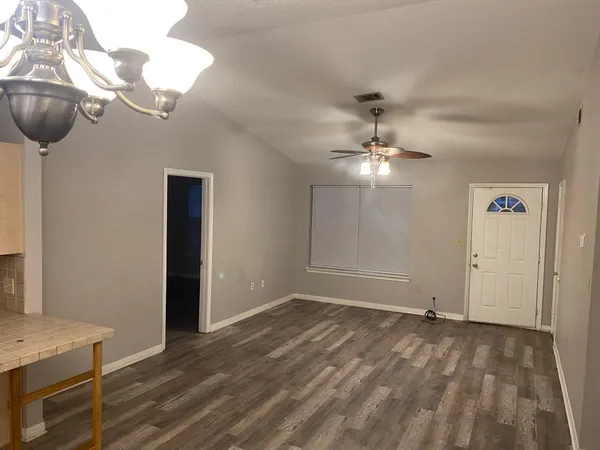 a view of a chandelier fan and wooden floor