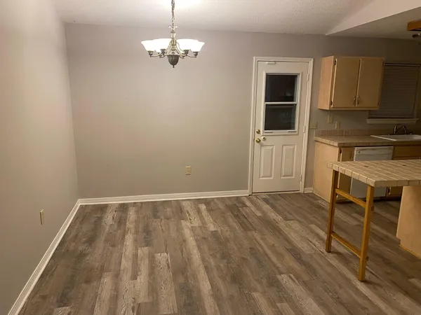 a view of kitchen and wooden floor