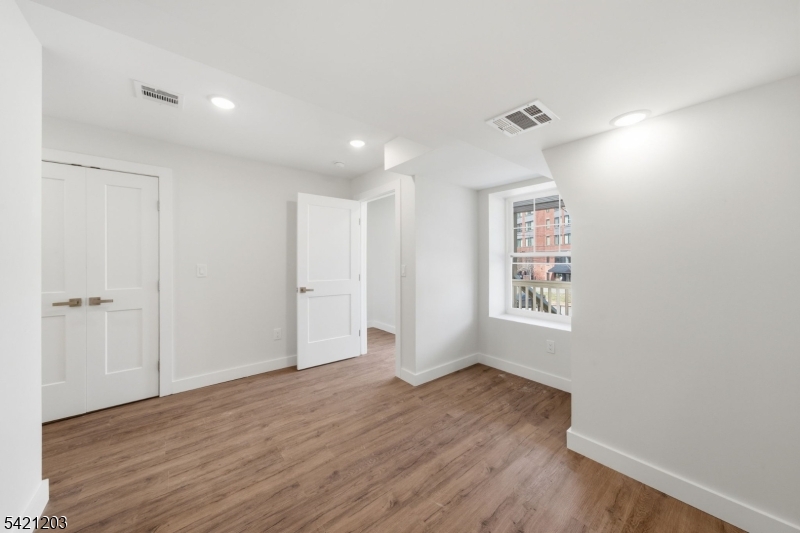 33 Clinton Place Morristown, NJ 07960 - Photo 15 of 24 a view of an empty room with wooden floor and a window
