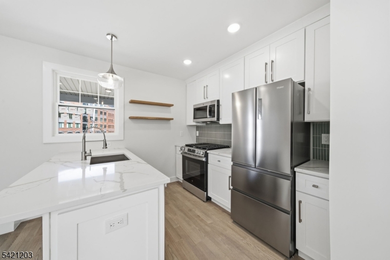 33 Clinton Place Morristown, NJ 07960 - Photo 4 of 24 a kitchen with granite countertop a refrigerator and a sink