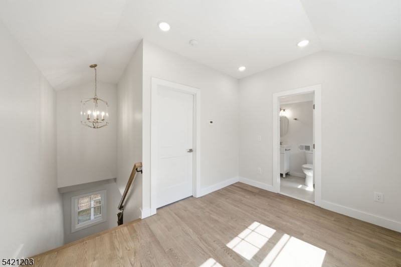 33 Clinton Place Morristown, NJ 07960 - Photo 9 of 24 an empty room with wooden floor and windows