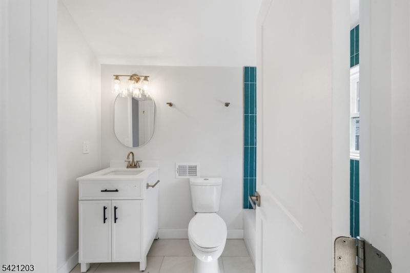 33 Clinton Place Morristown, NJ 07960 - Photo 10 of 24 a bathroom with a toilet sink and mirror