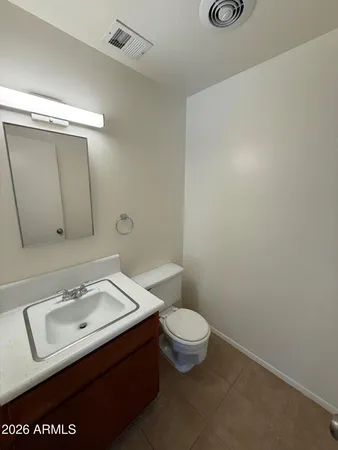 a bathroom with a sink a toilet and mirror
