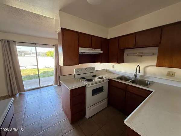 a kitchen with a stove sink and cabinets