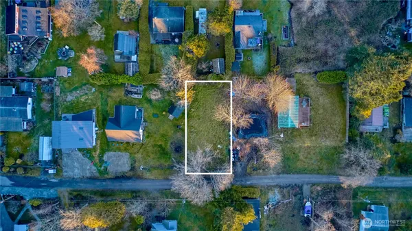 an aerial view of a houses with yard