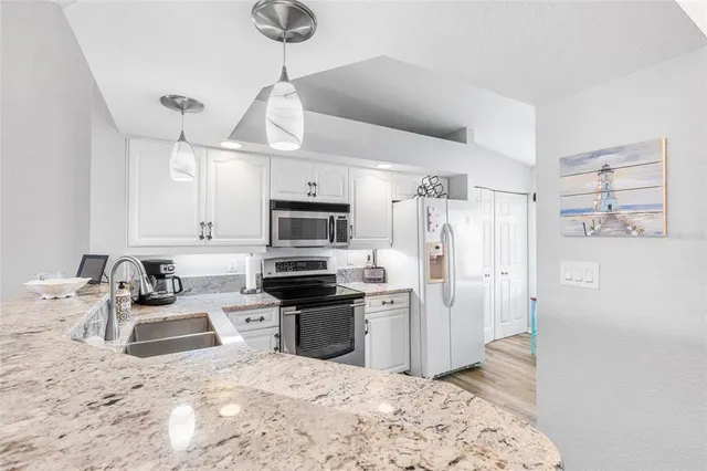 a kitchen with stainless steel appliances a stove sink and refrigerator