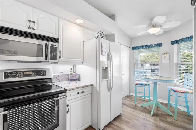 a dining room with furniture and a window