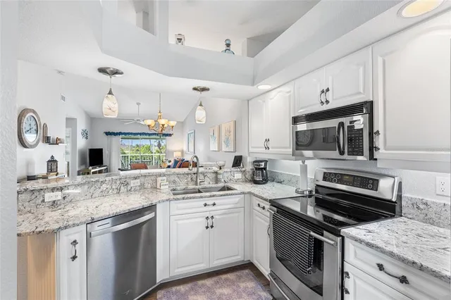 a view of a dining room with furniture and chandelier