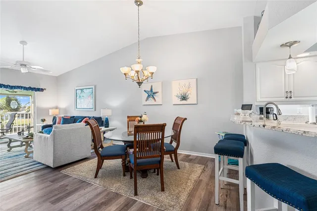 a view of a dining room with furniture and chandelier