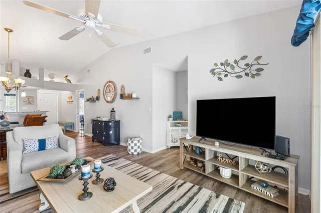 a living room with furniture a rug and a chandelier