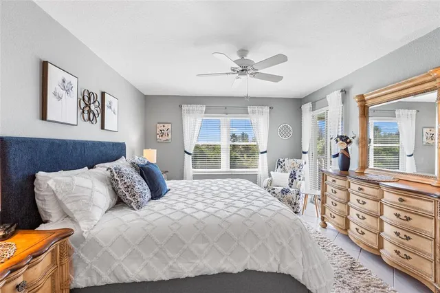 a bedroom with a large bed and a window