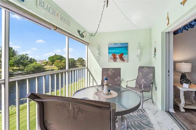 a dining room with furniture a chandelier and wooden floor