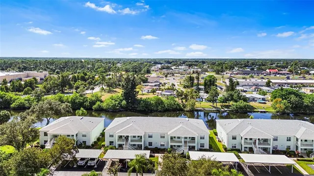 an aerial view of residential houses with outdoor space and ocean view