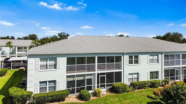 a front view of a house with yard and green space