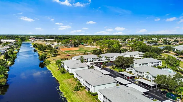an aerial view of residential houses with outdoor space and swimming pool