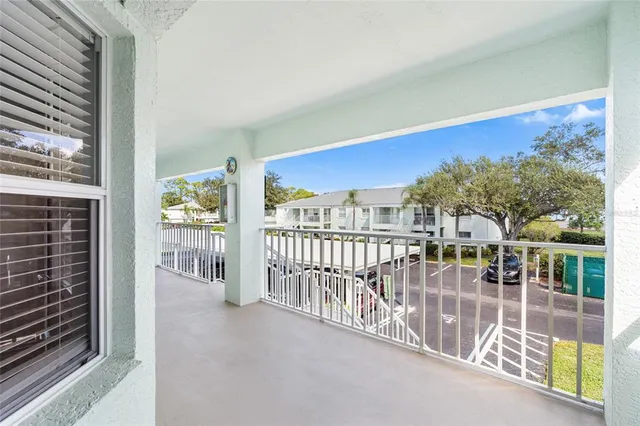 a view of a hallway with wooden floor windows and a chandelier