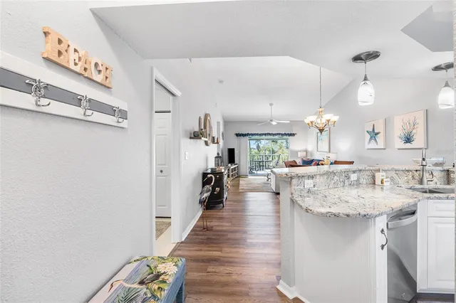 a kitchen with stainless steel appliances kitchen island granite countertop a sink and cabinets
