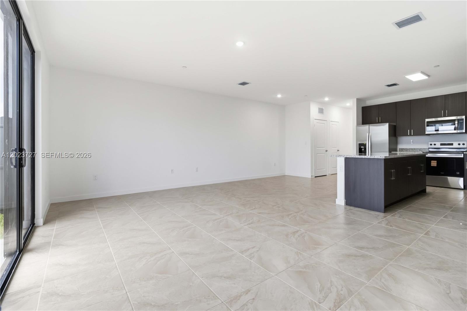 22348 Southwest 115th Court, Unit 22348 Miami, FL 33170 - Photo 6 of 37 a view of a kitchen with a sink and a microwave