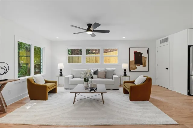 a living room with furniture potted plant and a window