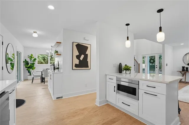 a kitchen with white cabinets and white appliances