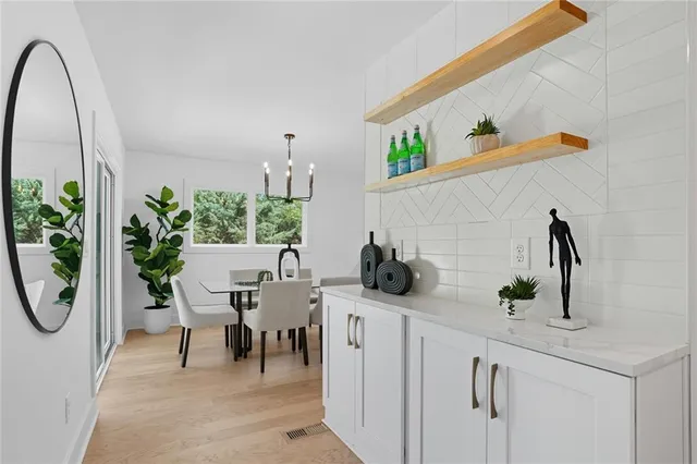 a living room with furniture a potted plant and a sink