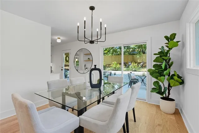 a dining room with furniture a chandelier and wooden floor