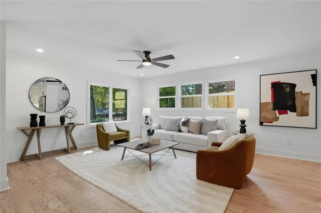 a living room with furniture a rug and a large window