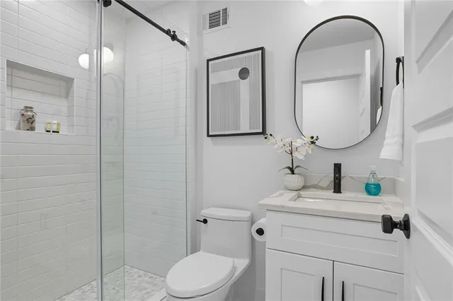 a bathroom with a toilet sink and mirror