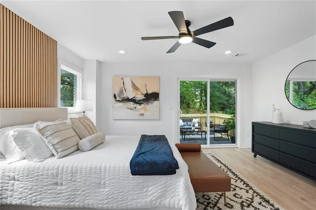 a bedroom with a large bed and a large window