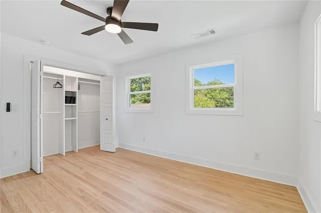 a view of empty room with wooden floor